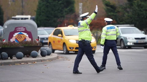 Police Office with face mask and gun directing traffic. Stock Footage 155953653