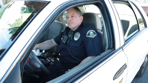 Police Officer getting into his patrol car Stock Footage 59165614
