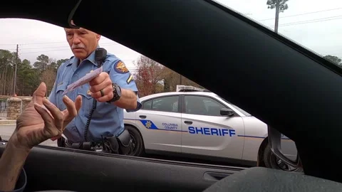 Police officer interacts with a driver with no face mask or gloves during the Video stock 148514957
