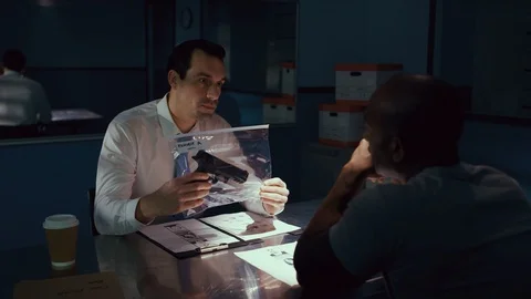 Police officer interrogating a suspect in a dark room Video stock 106824669