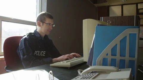 Police officer overworked at desk in old precinct Stock Footage 72973353