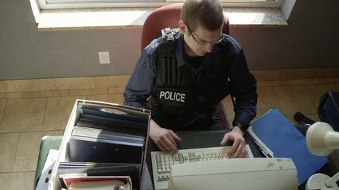 Police officer overworked sits back in chair Stock Footage 72973703