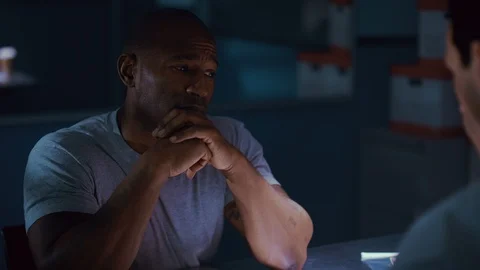 Police officer questioning the suspect in the interrogation room Stock Footage 106832216