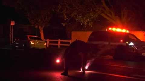 Police officer setting up road flares | Stock Video | Pond5