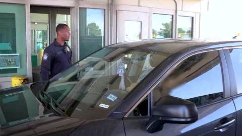 Police oficer checking documentation at Bridge of the Americas Port of Entry Stock Footage 284083733