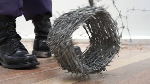 Police or security guard roll out Barbed wire on floor Stock Footage 94215475
