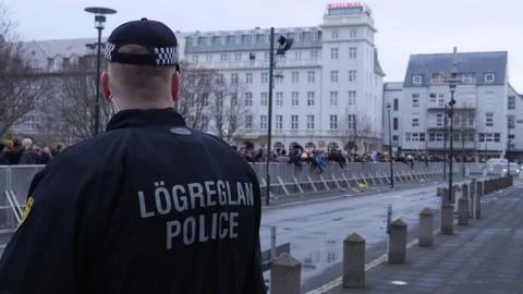 Police with protestors in background Stock Photos