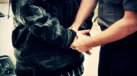 Police putting on handcuffs with filter Stockbeeldmateriaal 42875538
