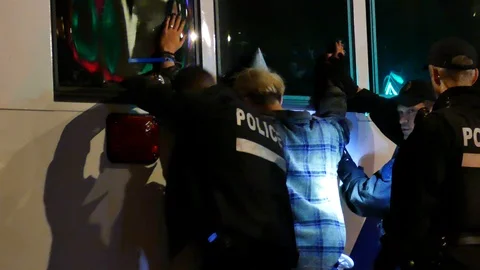 Police putting under arrest young man Stock Footage 120107153
