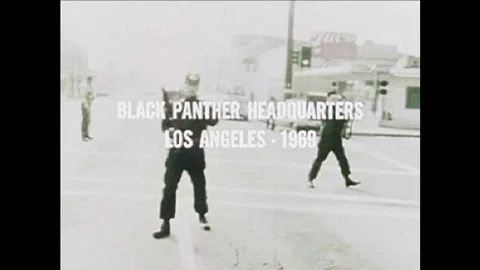 A police raid on black panther headquarters in the 1960s shows racial strife. Stock Footage 100615367