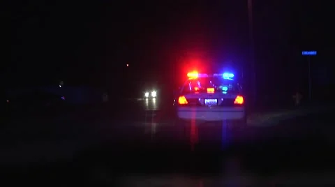 Police speeding to a scene at night Stock-Footage 42877241