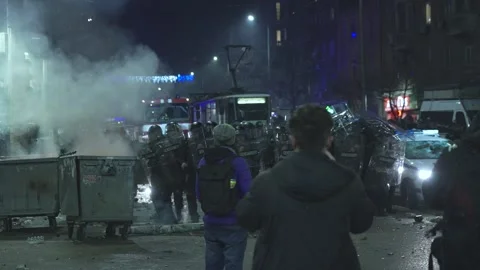 A police squad protects itself from hooligans at night in Sofia 스톡 동영상 324557587