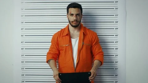 In a Police Station Arrested Man Posing for Mugshot. He's Is Heavily bruised Stock Footage 78176609