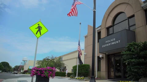 Police station with flags at half mast Video stock 65383589