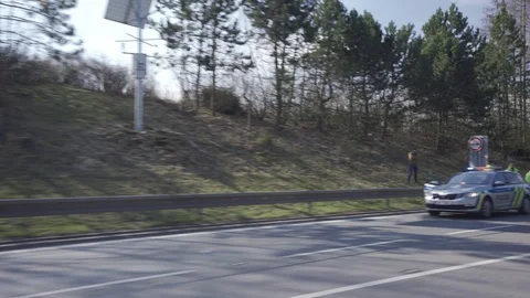 Police stopped traffic causing jam on a flat road in the middle of nature Stock Footage 126569689