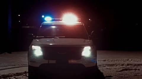 Police SUV With Lights Flashing During Snowstorm Stock Footage