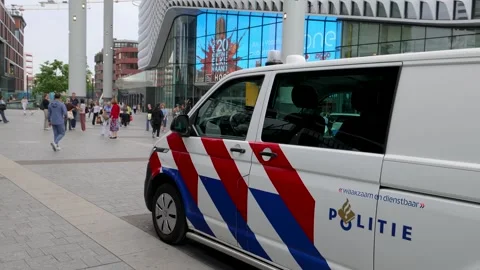 Police van parked in front of the central train station area in Utrecht Stock Footage 339582077
