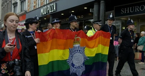 Police Walking Through Colourful Pride Parade Celebrating LGBTQ Rights  Stock Footage 113523758