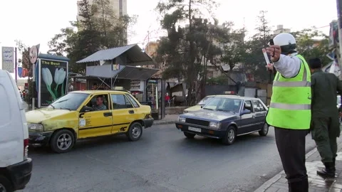 Policeman directing traffic at an intersection in Aleppo, Syria Stock Footage 155313760