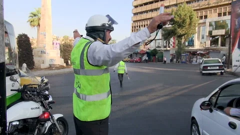 Policeman directing traffic at an intersection in Aleppo, Syria Stock Footage 155313928