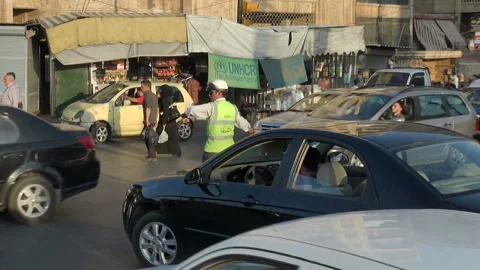 Policeman directing traffic at an intersection in Aleppo, Syria Stock Footage 155314050