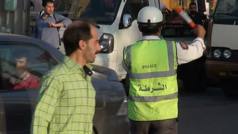 Policeman directing traffic at an intersection in Aleppo, Syria Stock Footage 155314107