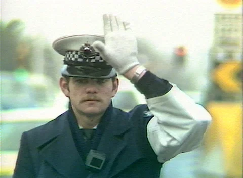 POLICEMAN DIRECTING TRAFFIC OUTSIDE FLINDERS ST STATION, MELB, AUSTRALIA (1984) Stock Footage 251943237