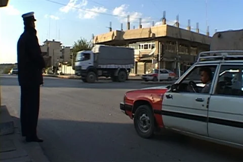 Policeman directs traffic into intersection. Stock Footage 86753607