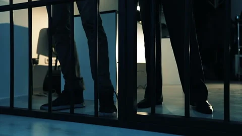 A policeman leads a criminal into the prison cell. Stock Footage 88330471