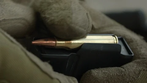 Policeman load ammo. Slow Motion. 4K (UHD). Stock-Footage 107122189