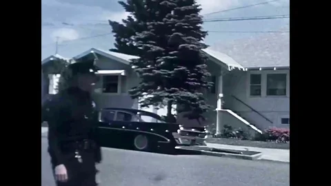 A policeman performs a routine neighborhood canvas to collect witness statements Stock Footage 95367893