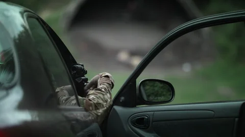 The policeman shoots while in the car. Fire support. special operation. Stock Footage 107521365