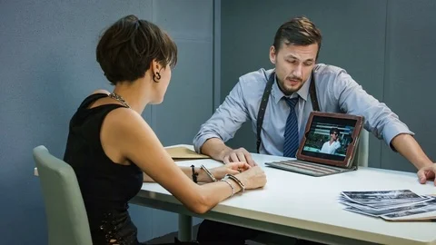 Policeman shows pictures on the tablet for suspect the girl and her crimes Video stock 70353953