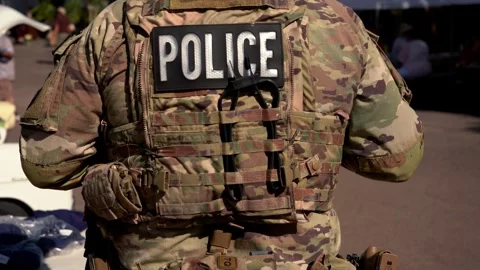 A policeman standing guard in full camo uniform Stock Footage 276670654