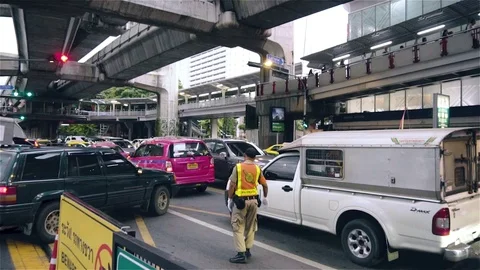 Policeman Winking through traffic in slow motion Stock Footage 81326357