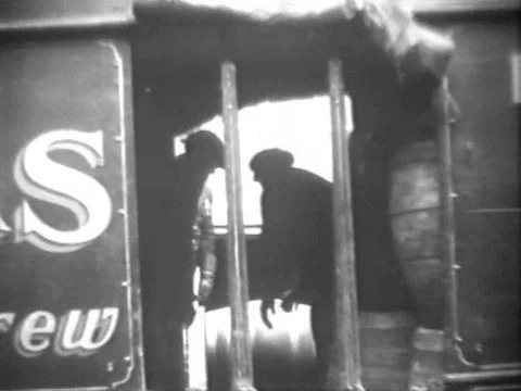 Policemen escort trucks carrying beer in Chicago, Illinois, in 1933. Stock Footage