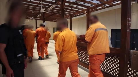 Policemen evacuate prisoners from Prison, blurred faces Stock Footage