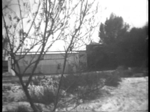 Policemen raid a bootlegging plant in Downey, California, in 1932. Stock Footage