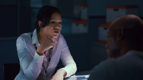 Policewoman interrogating criminal in interrogation room Stock Footage 106835937