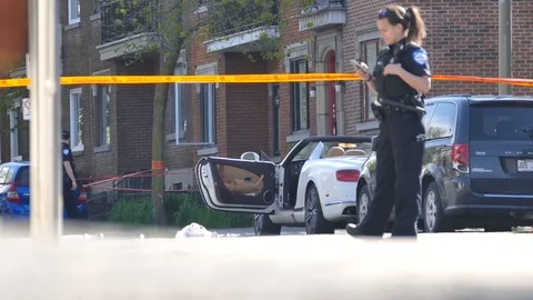 Policewoman texting with crime scene in the background Stock Footage 90362333