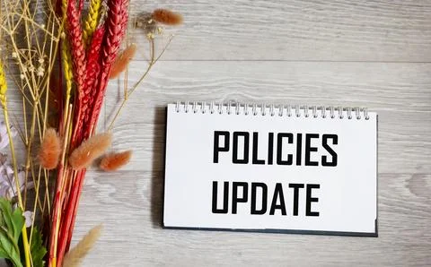 The policy update message is written on a notepad with a beautiful backgrou.. Stock Photos