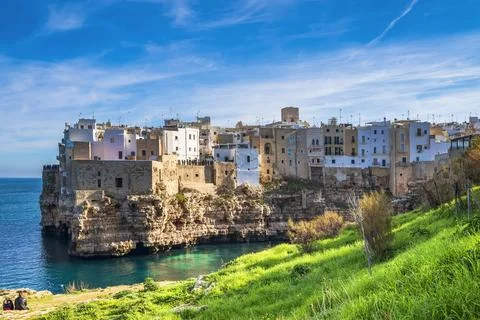 Polignano a Mare known for its dramatic coastline, characterized by rugged .. Stock Photos