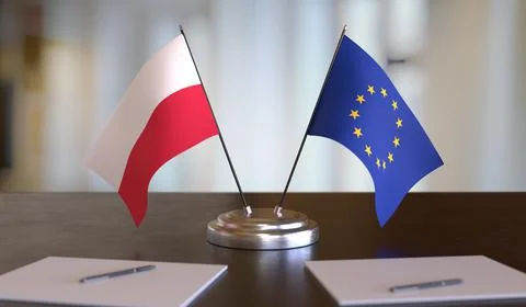 Polish and EU flags on table. Negotiation between European Union and Poland.  Stock-Fotos