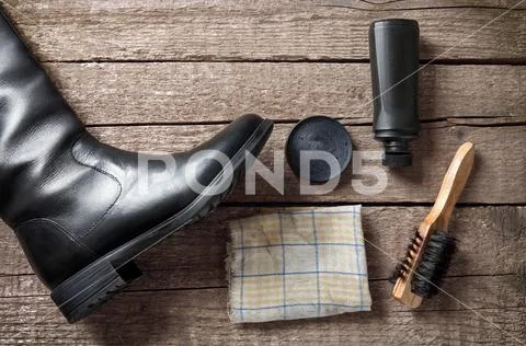 Polish cream,brush,dirty cloth and black boot Stock Photos