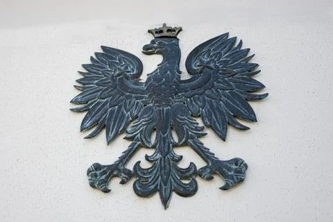 Polish eagle emblem displayed as decorative metal detail on concrete wall Stock Photos
