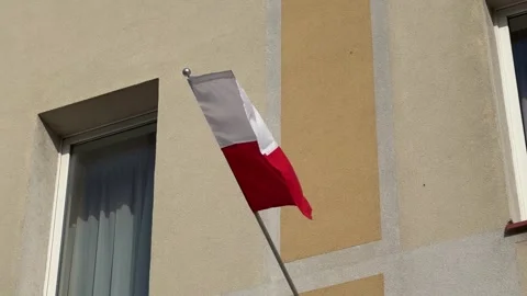 Polish flag waving at strong wind with building at background Stock Footage 290932502
