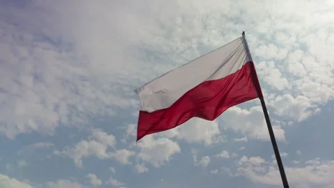Polish flag waving in the wind against a blue sunny sky. Stock Footage 310176378