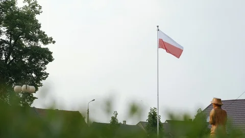 Polish flag waving in the wind in a small town. Poland. Video stock 107166593
