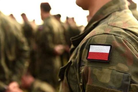 Polish patch flag on soldiers arm. Poland military uniform. Poland troops Stock Photos