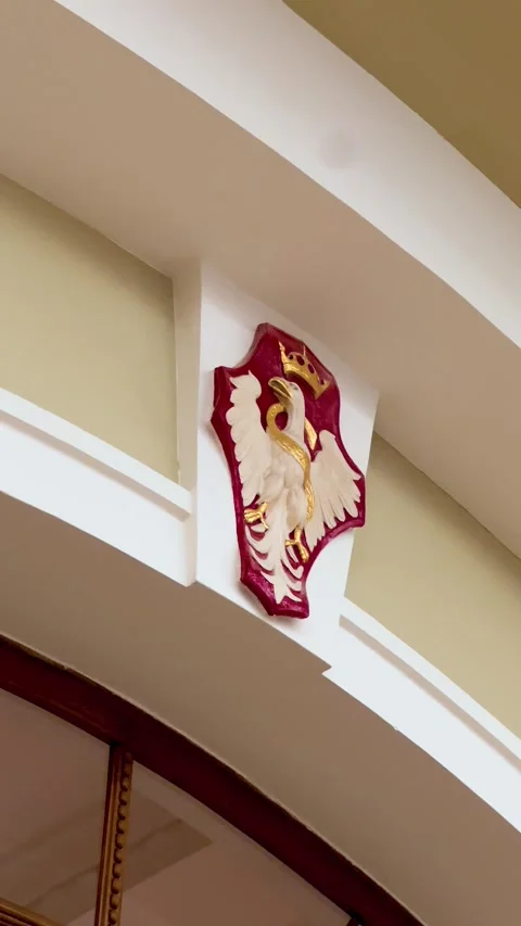 Polish white eagle coat of arms mounted above doorway inside public building Stock Footage 335706511